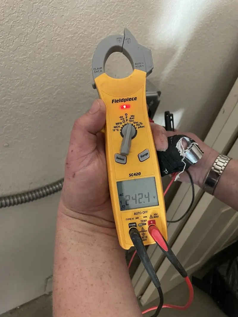 Voltage testing with clamp meter during Outlet Installation in Wharton
